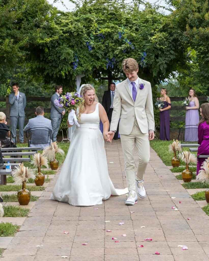 walking back down the aisle as a married couple at The Barn at Blueberry Hill wedding venue with lodging located in Elkin NC near Winston-Salem and Charlotte